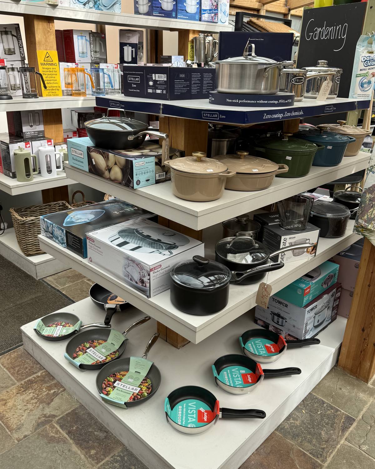 White display shelves of saucepans, casseroles, roasting tins and mixing bowls